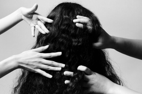 black and white photo of hands and hair by Emilio Daniel