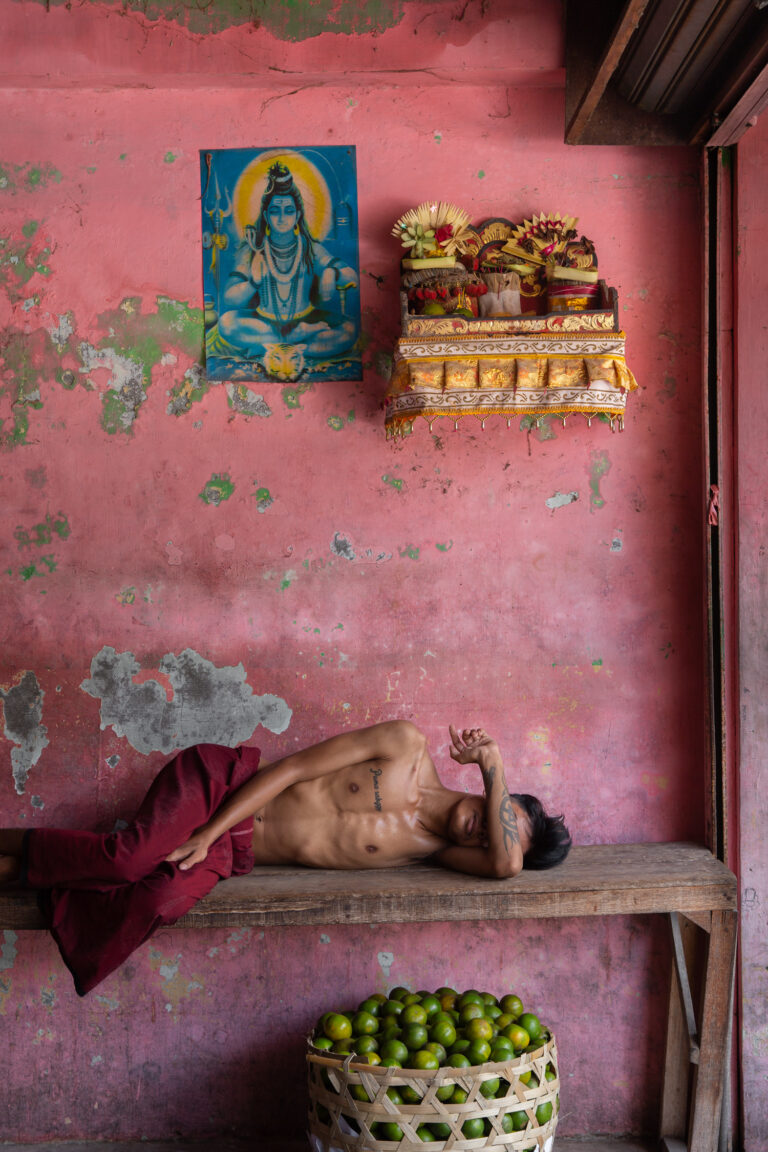 Color photography by Michael Dean Morgan, man, sleeping, pink room, Bali