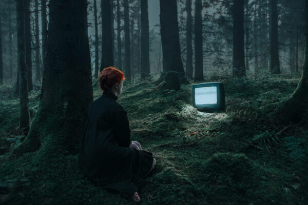 color conceptual fine art photo of woman and tv in woods by Ruby Hyde