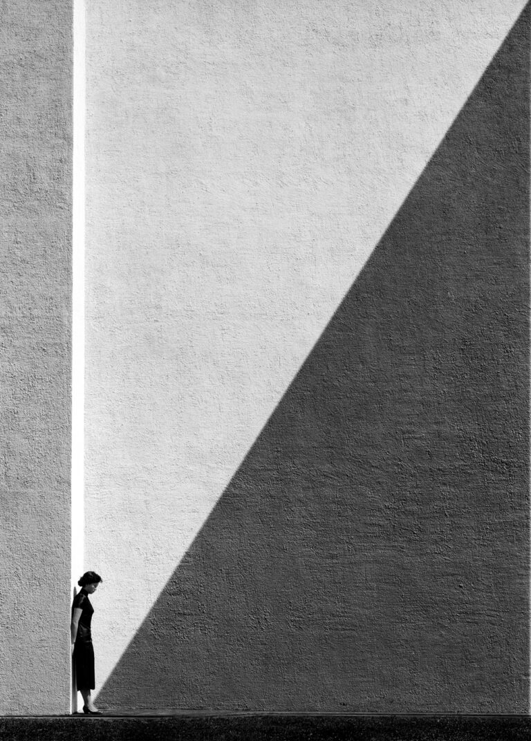 Black & white street photography by Fan Ho. Woman, shadows, Hong Kong