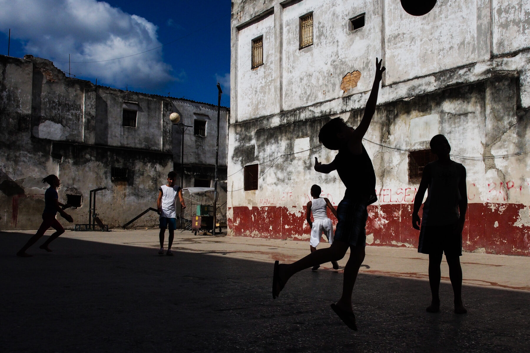 Color street photography by Andrea Torrei, boys playing soccer, Havana, Cuba