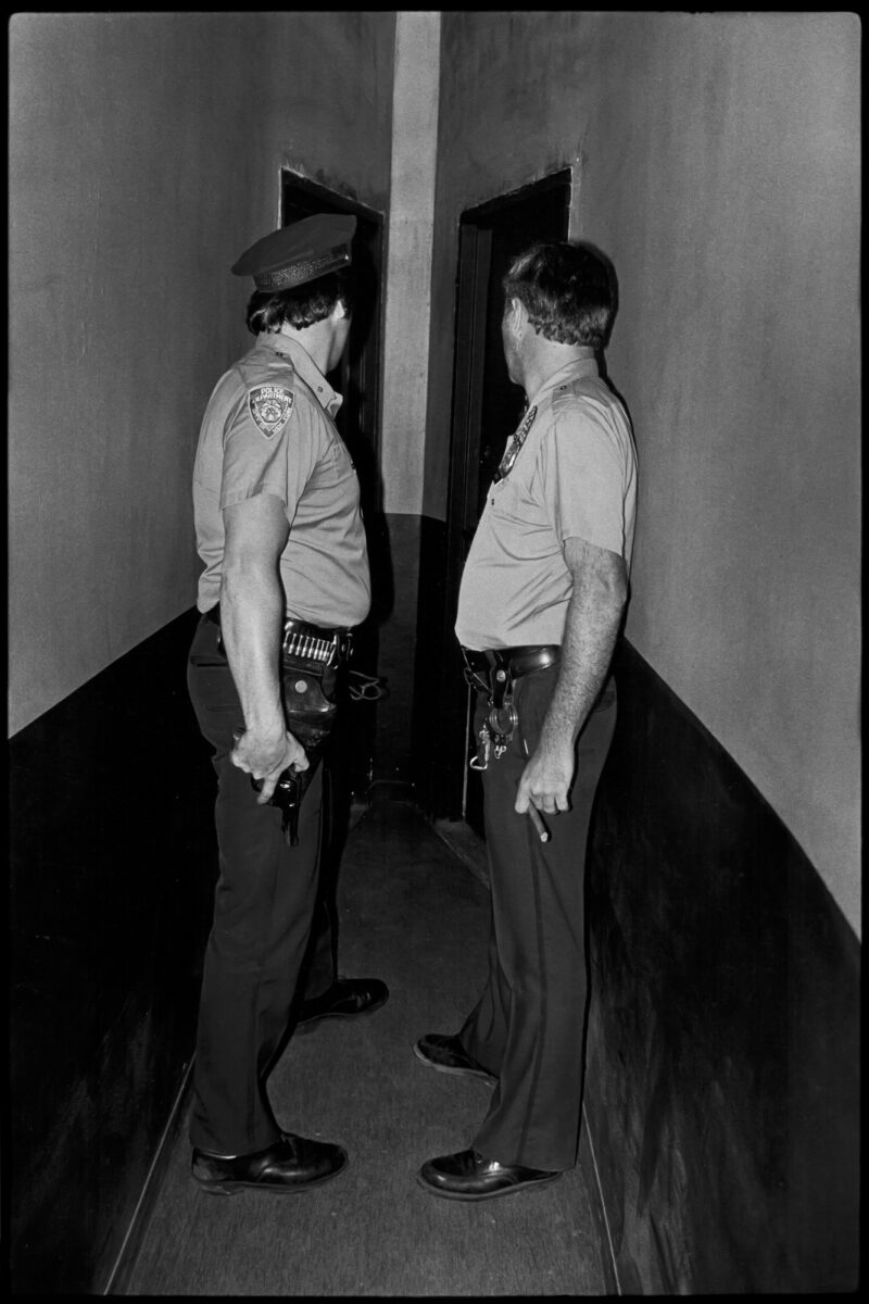 Two cops in angles hallway, NYC, street photography by Jill Freedman from 'Street Cops'