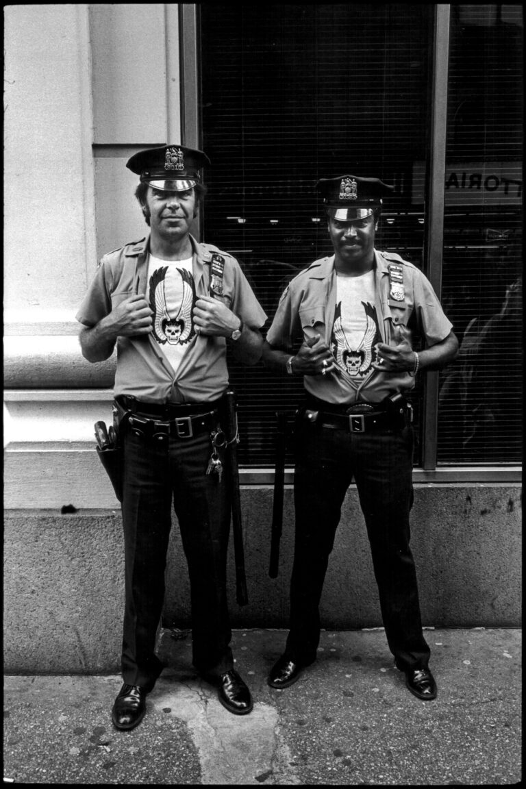 Cops Showing Off Their Tshirts. NYC, street photography by Jill Freedman