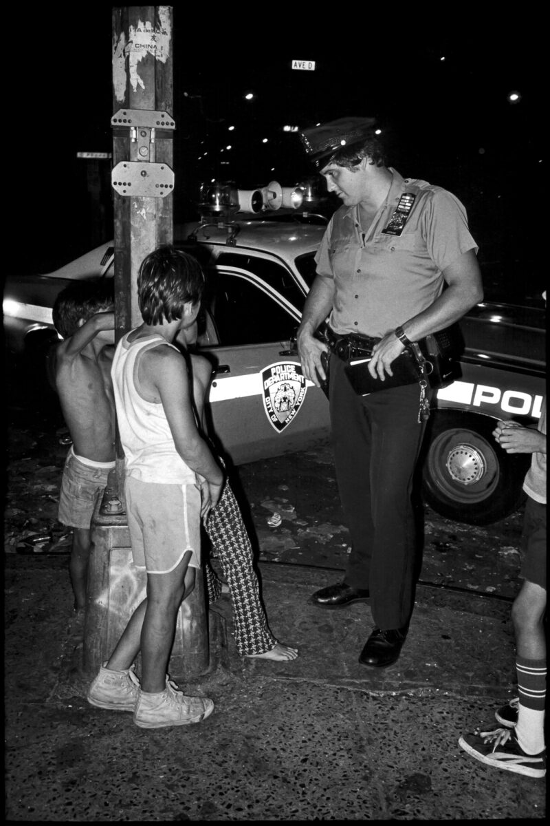 Cop With 3 Kids. NYC, street photography by Jill Freedman