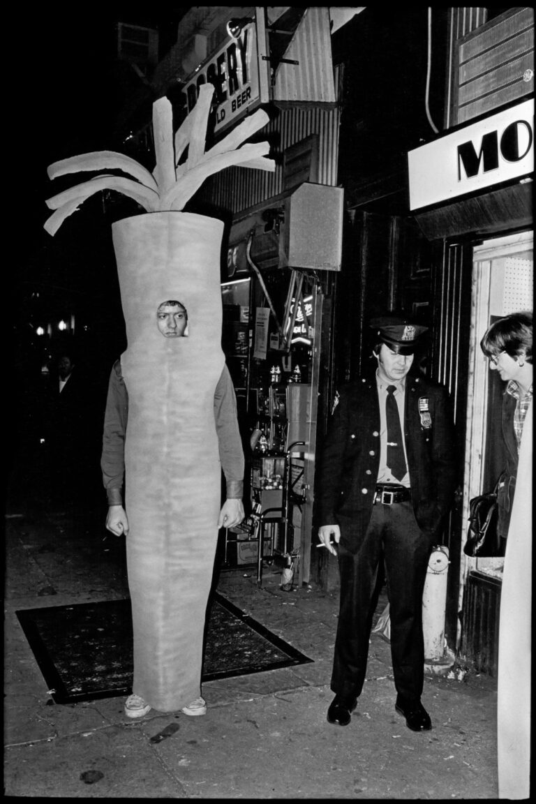 Cops with man in carrot suit, NYC. Street photography by Jill Freedman from 'Street Cops'