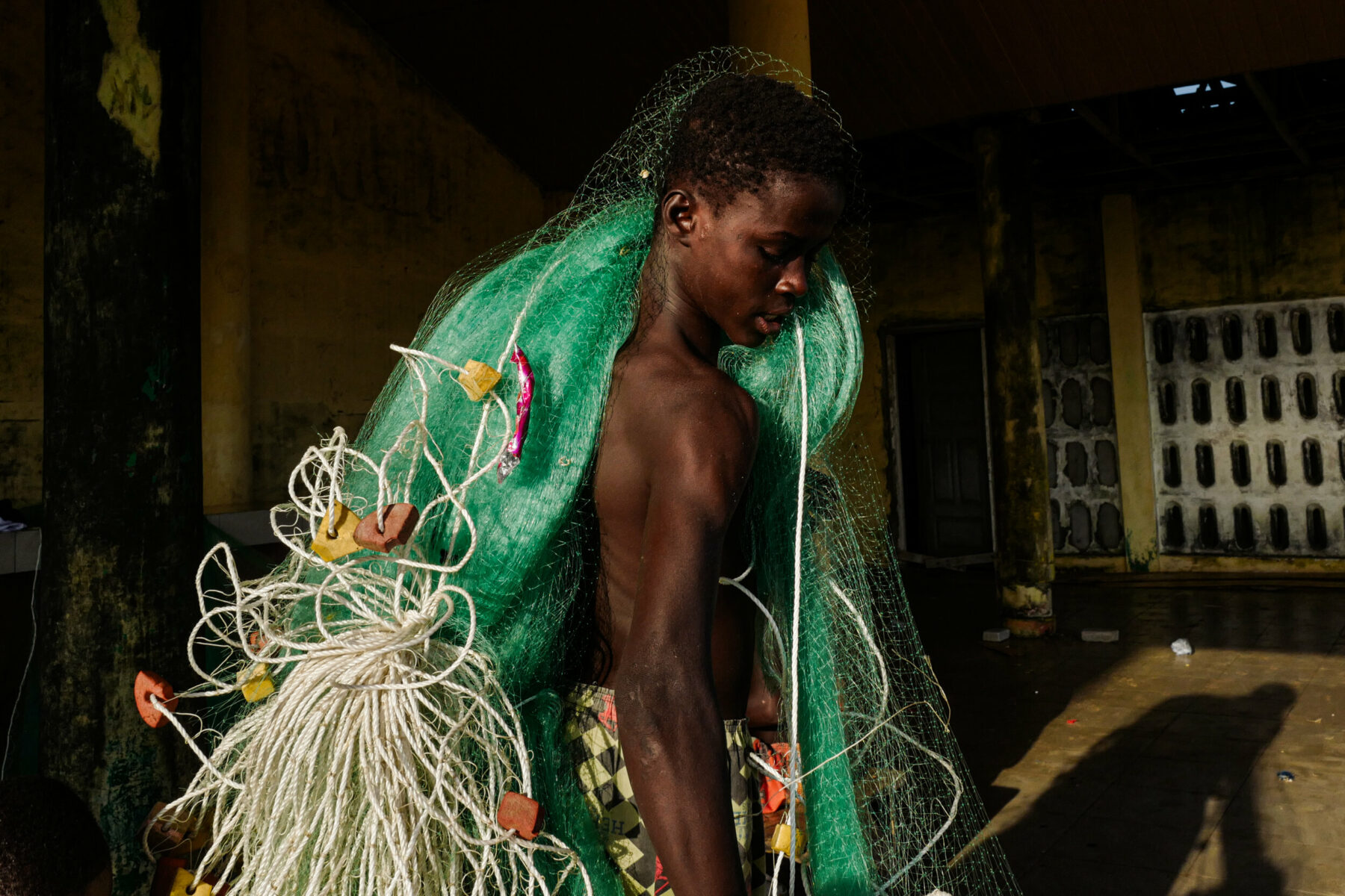 Color portrait, street photography by Andrea Torrei, Fisherman Ghana, from Realities Hidden Within