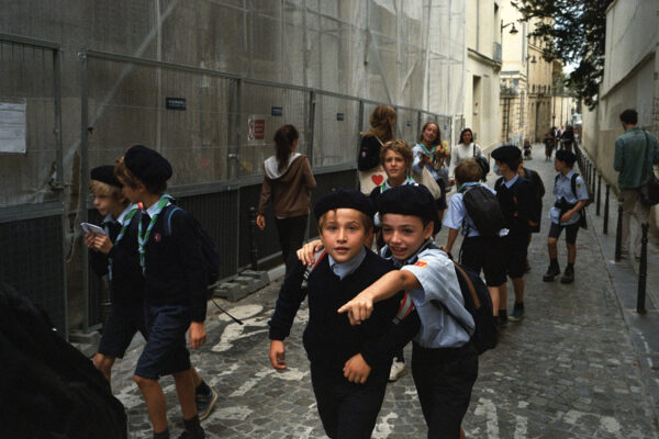 color street photo of scouts children in the street of Paris, France by Valentine de Villemeur