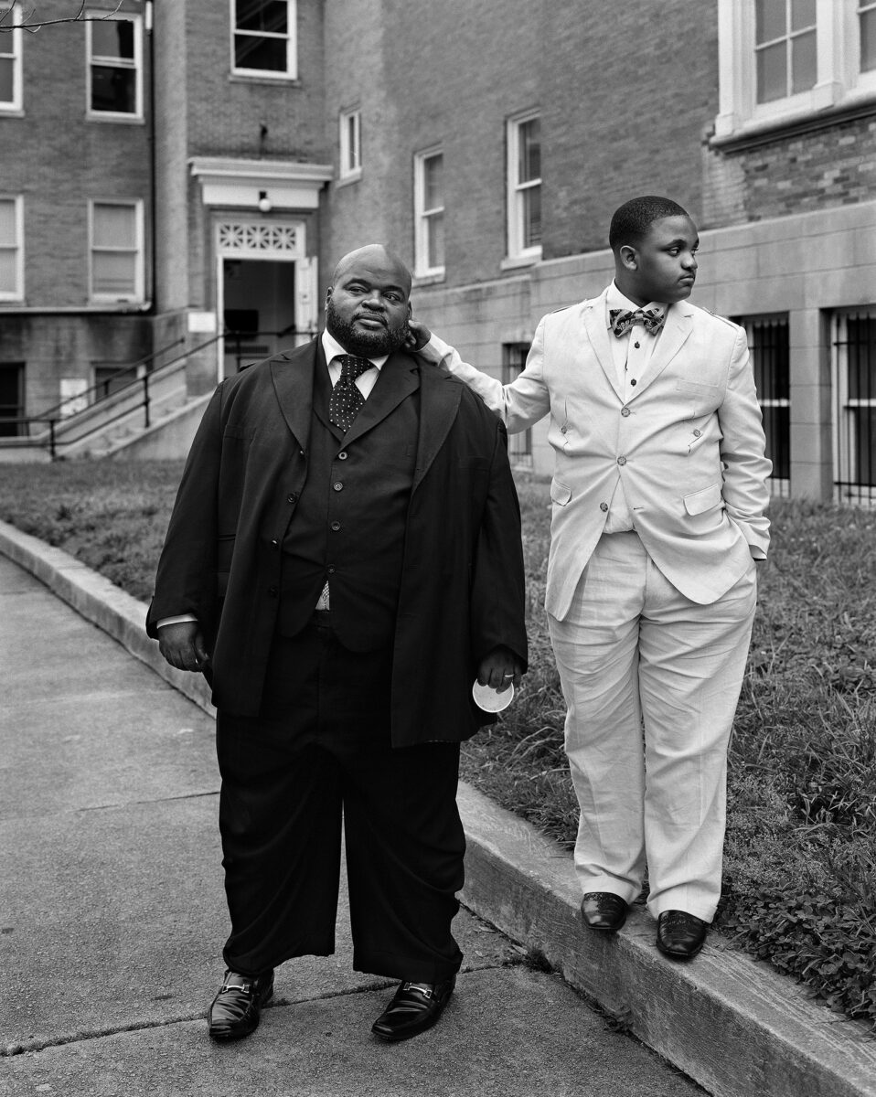 Black & white portrait photography by Vanessa Winship, man and youth in suits.