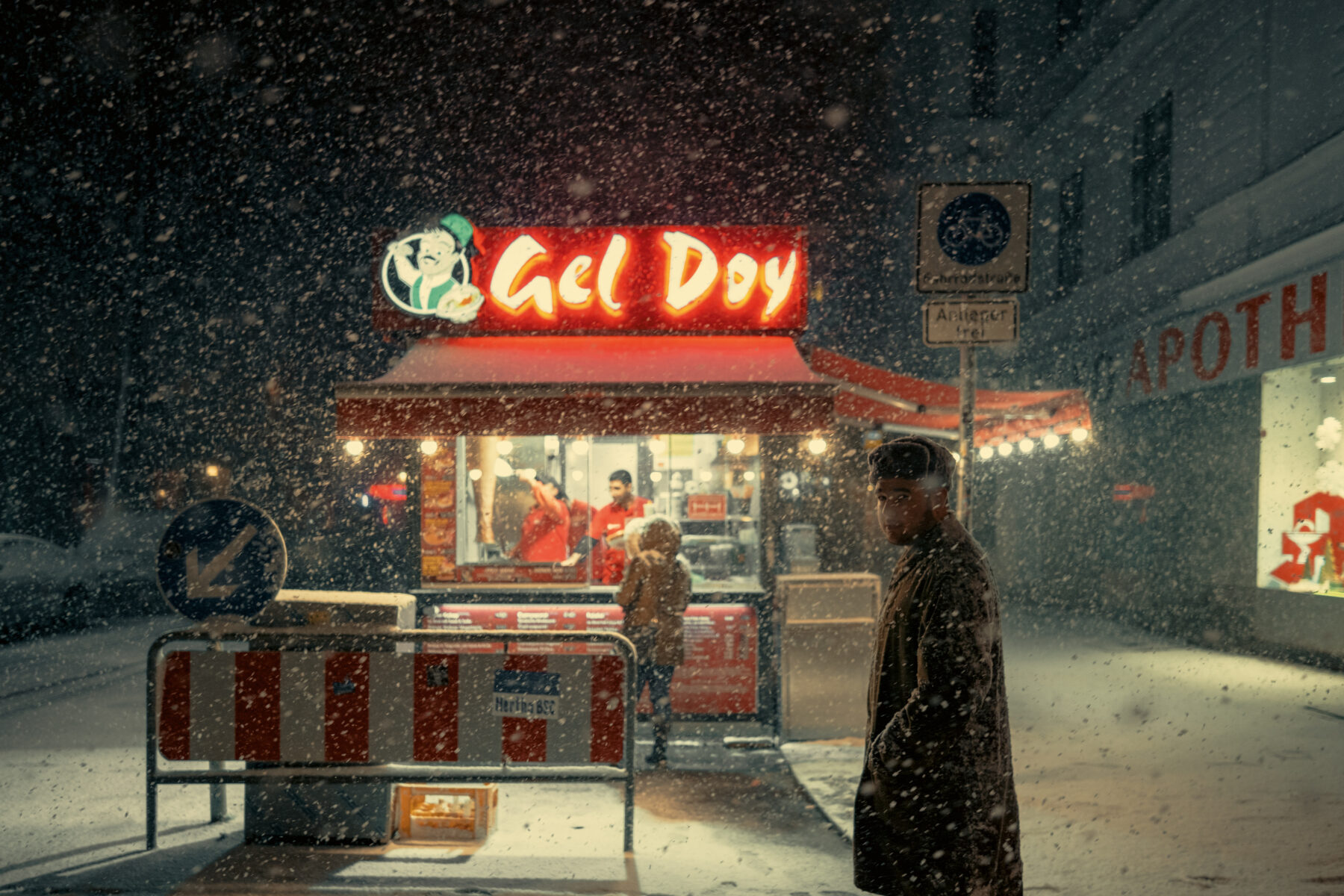 night street photo of a man in snow in Berlin by Dovlet Annayev