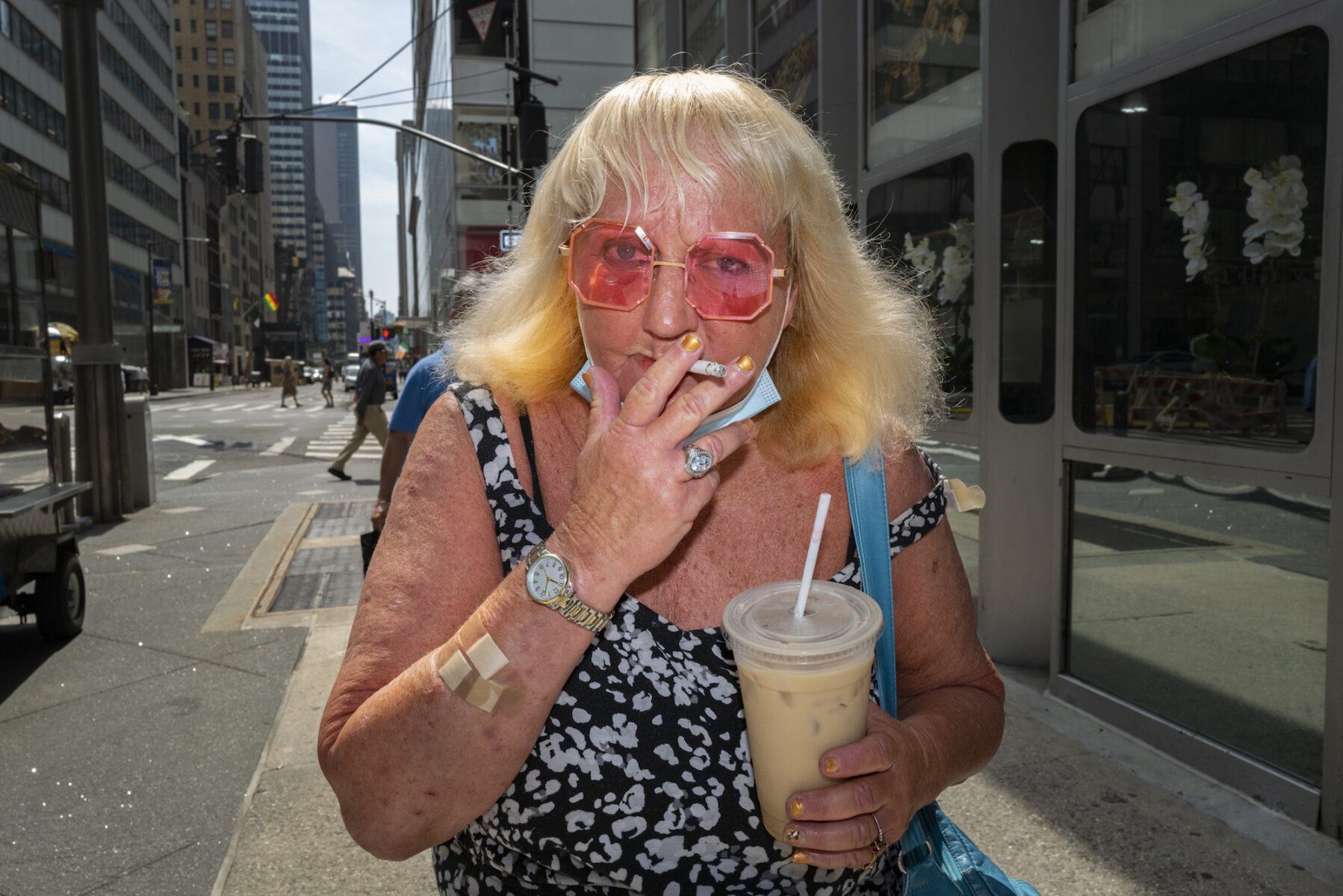 color portrait of a woman smoking a cigarette in Manhattan, New York, USA by Ilya Nikolayev