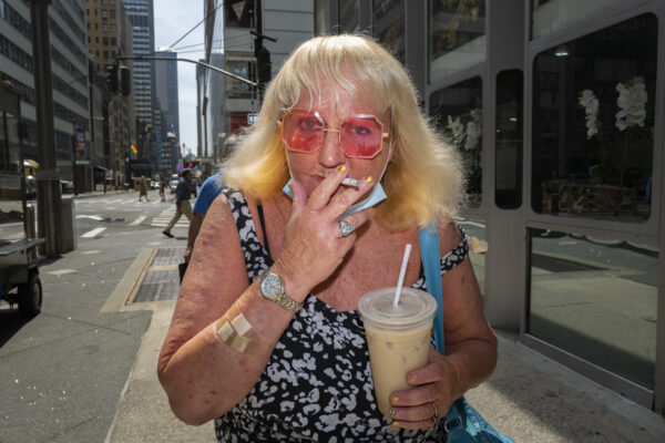 color portrait of a woman smoking a cigarette in Manhattan, New York, USA by Ilya Nikolayev