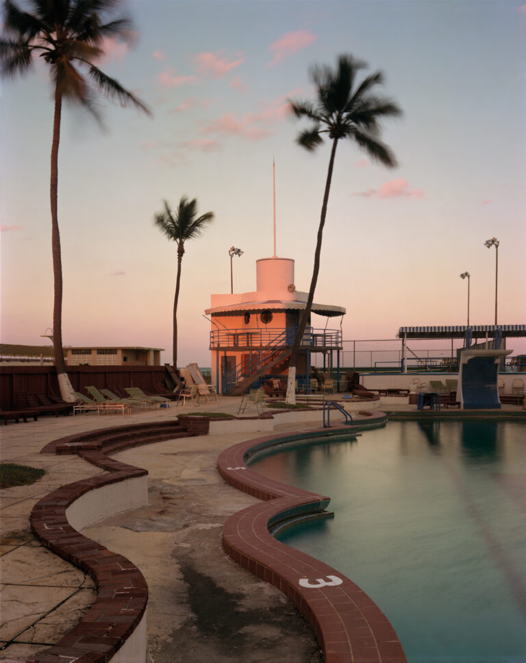 Miami Beach, Florida, 1978. Joel Meyerowitz. Color film photography of swimming pool, sunset, dusk