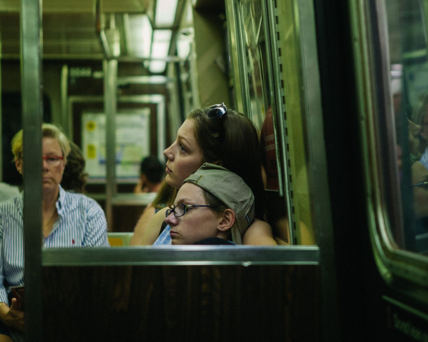 Street photography by Young Chul Kim, mother and son on train