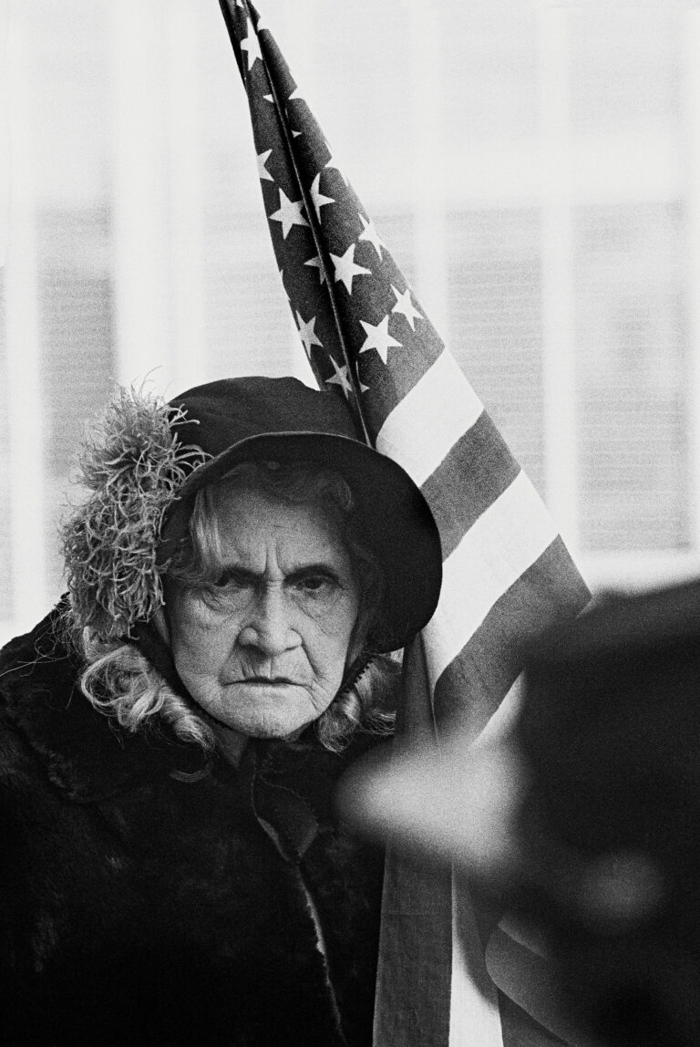 Black and white photography by Thomas Hoepker, Lady with US flag in the Fourth-of-July parade.