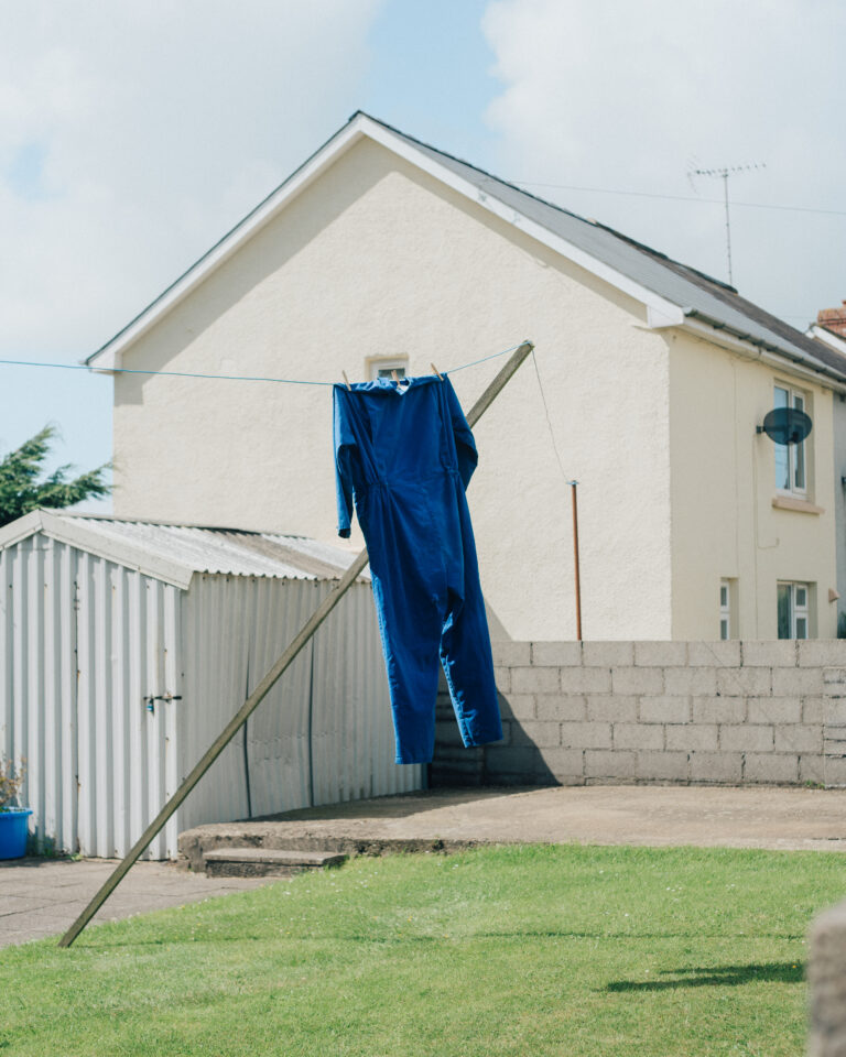 Street photography by Young Chul Kim, overalls on washing line.