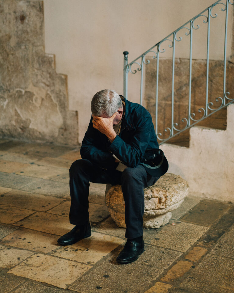 Street photography by Young Chul Kim, portrait of man with head in hands, from, Feeling Before Seeing