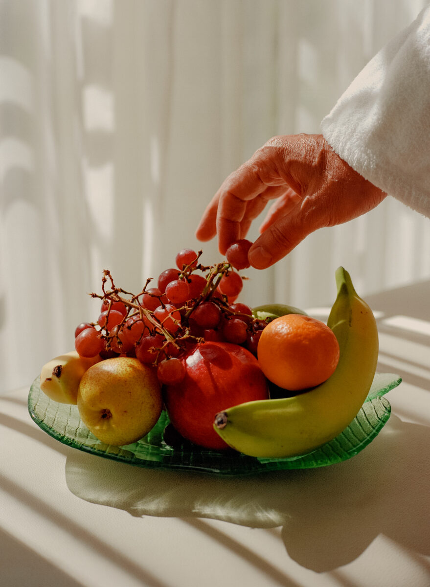 color photo of a hand with fruit bowl by Jonah Reenders