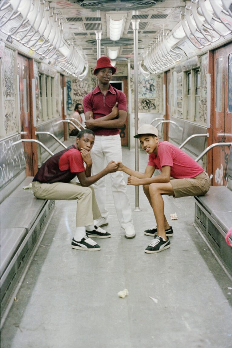 Street photography by Jamel Shabazz, portrait of men on subway, Brooklyn, 1980