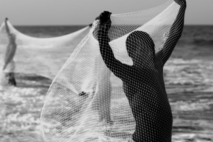 Black and white photography portrait by Mário Macilau, young boy fishing