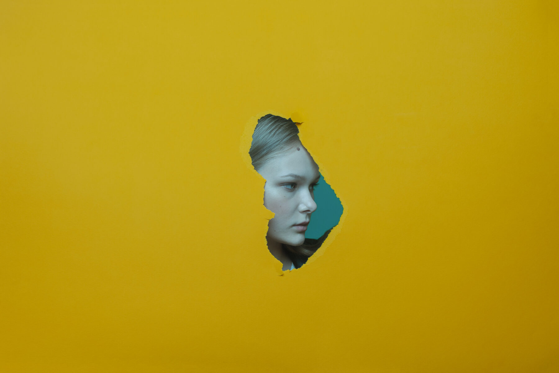 Color photography by Paolo Baretta. portrait of woman, yellow background