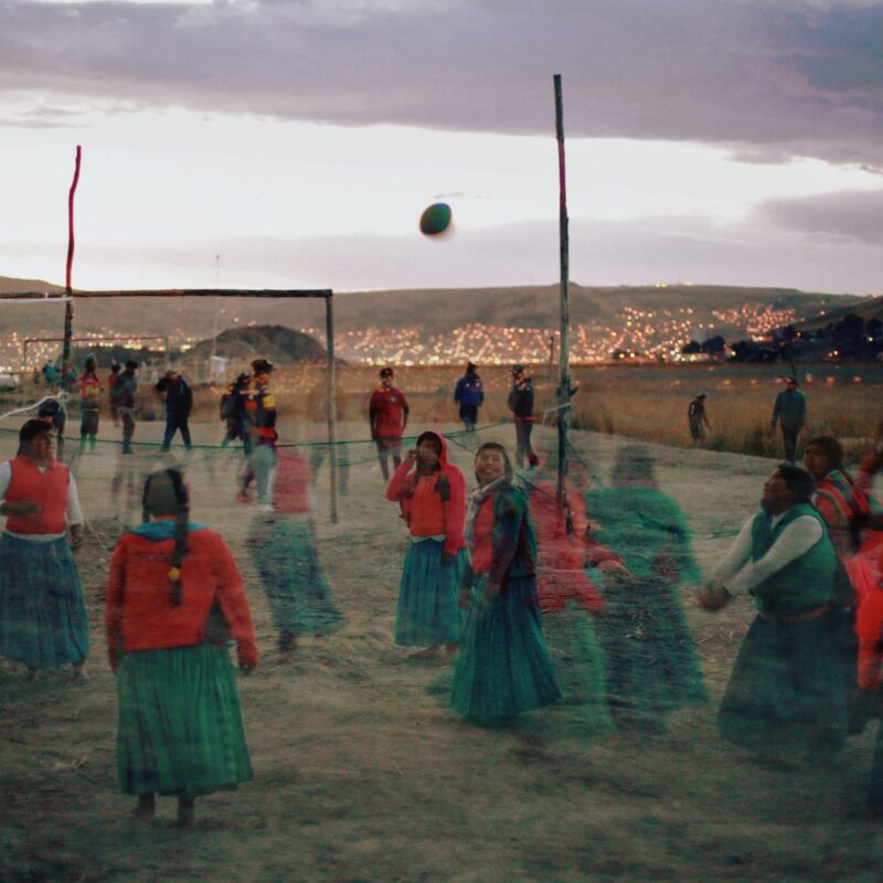 color photo of Women playing volleyball on the Titicaca Lake in Peru by Felicia Simion