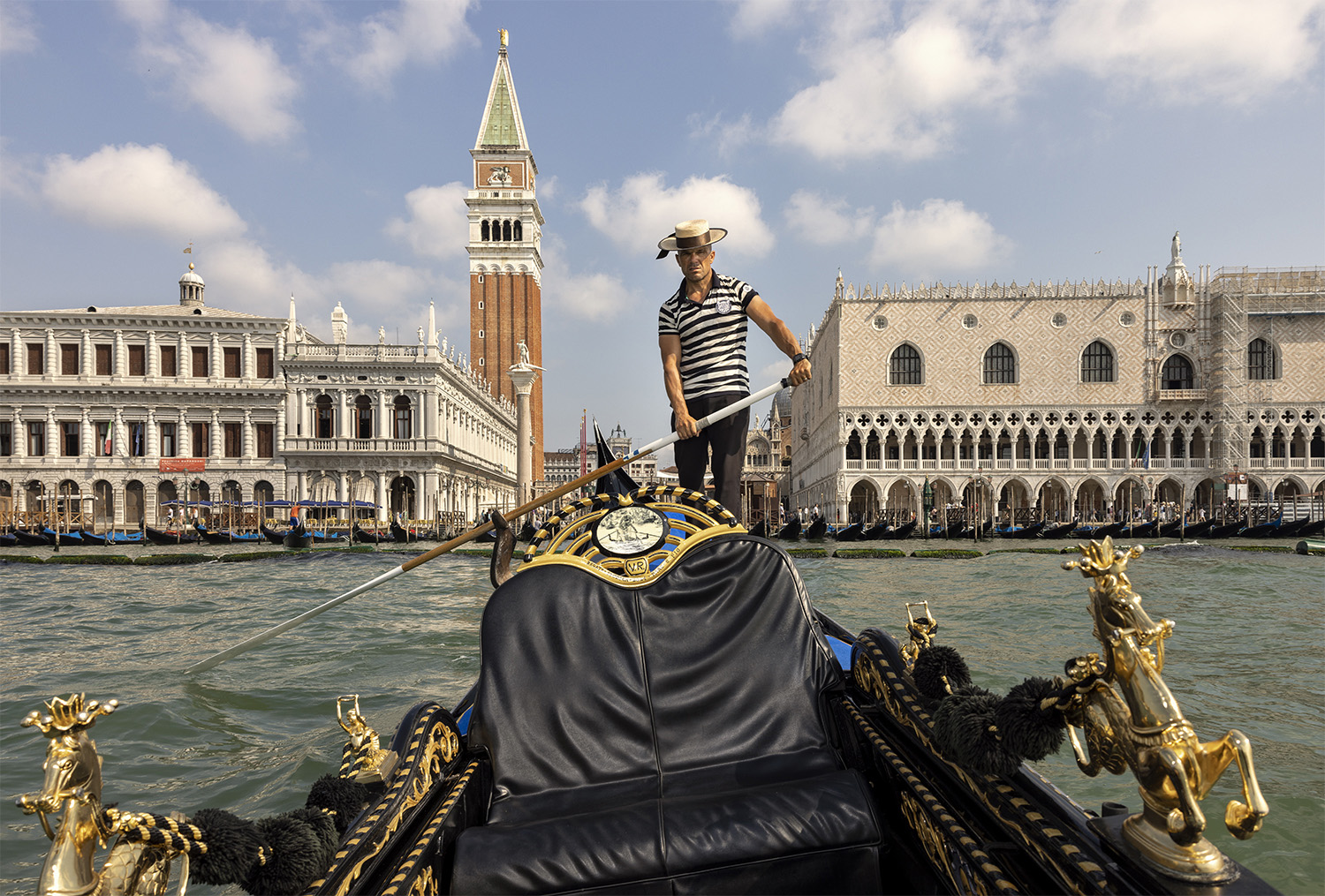 color travel photo of man on boat in venice by Mauro De Bettio