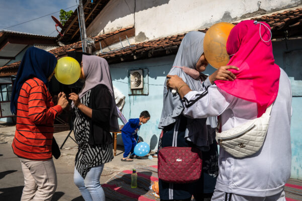 color street photo of women in Tegal, central java by David Keith Brown