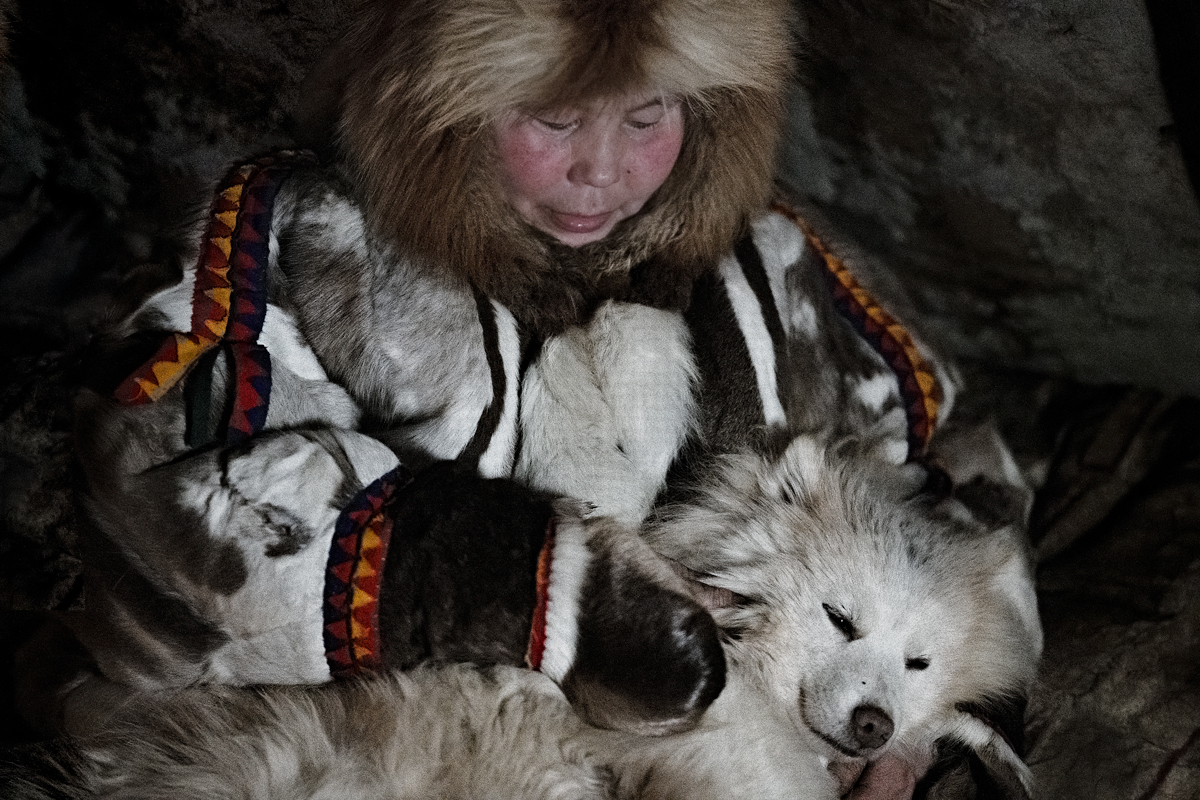 Color documentary photography portrait by Nicola Ducati, Nenets woman and dog, Siberia