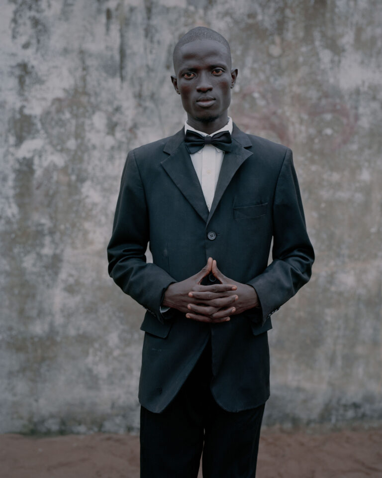 Color portrait documentary photography by Elliott Verdier, man in suit and bow tie