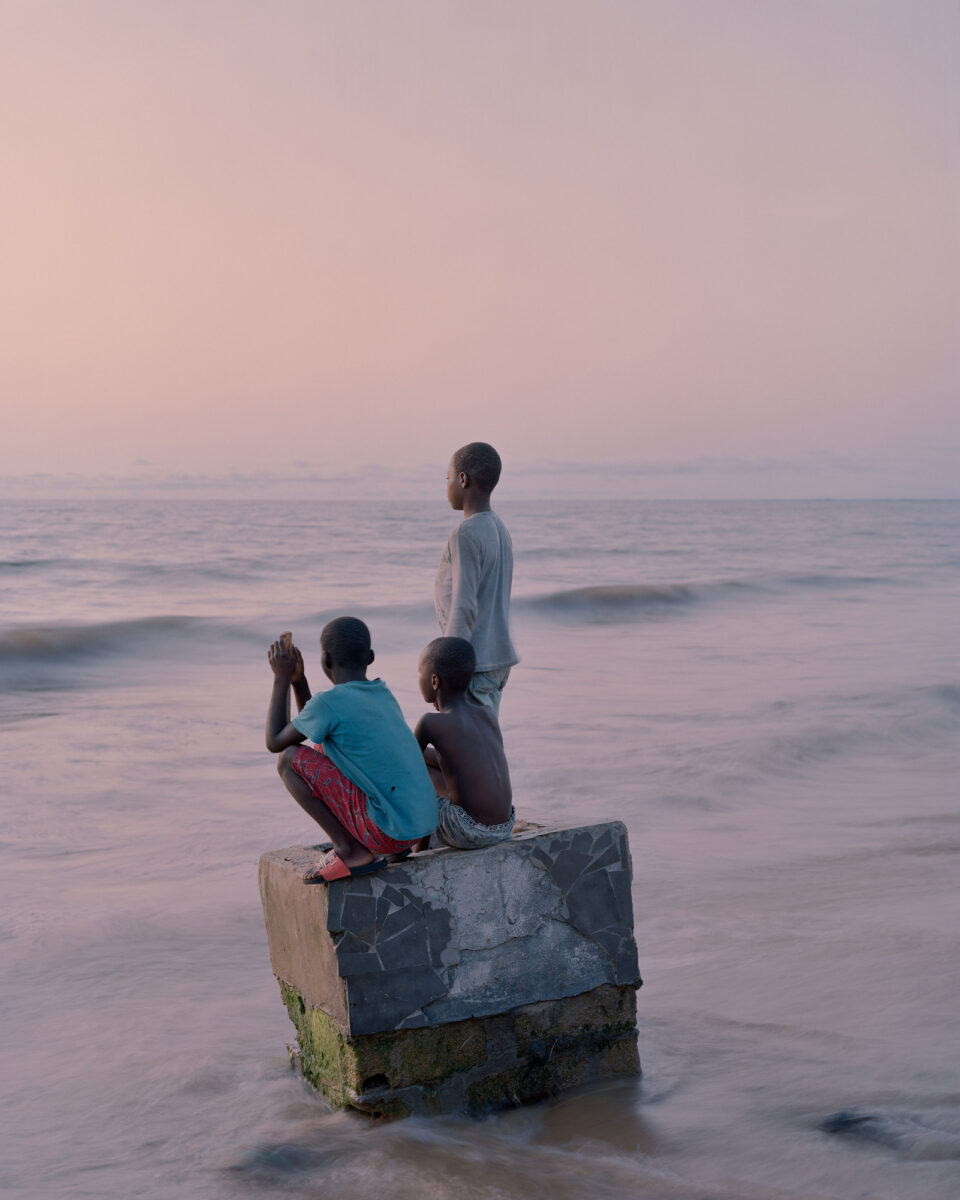 Color portrait documentary photography by Elliott Verdier, boys on beach, Liberia, sunrise