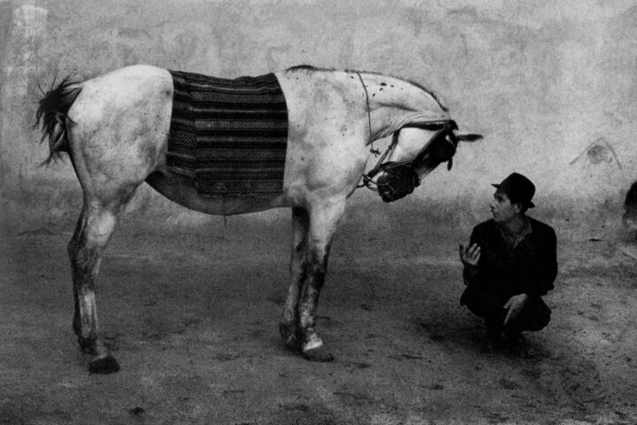 Black and white photography by Josef Koudelka, man and horse