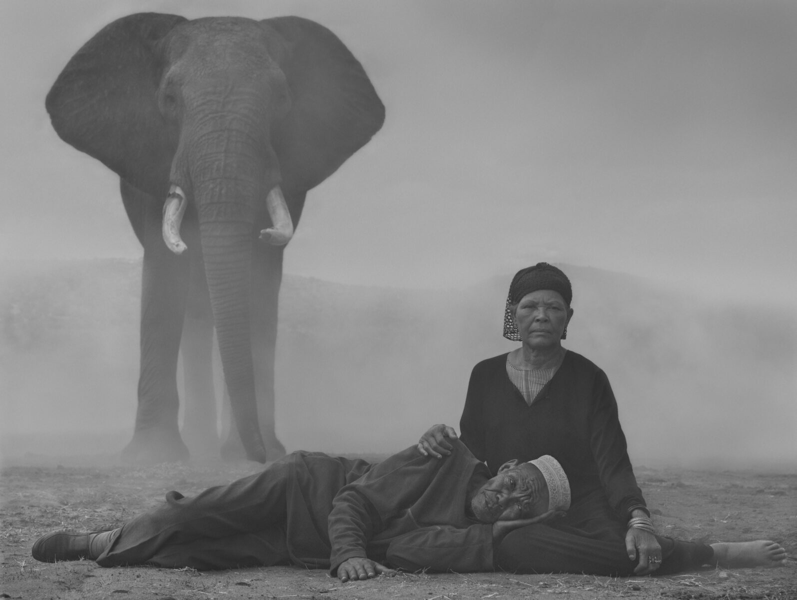 Black and white portrait of man, woman and elephant by Nick Brandt