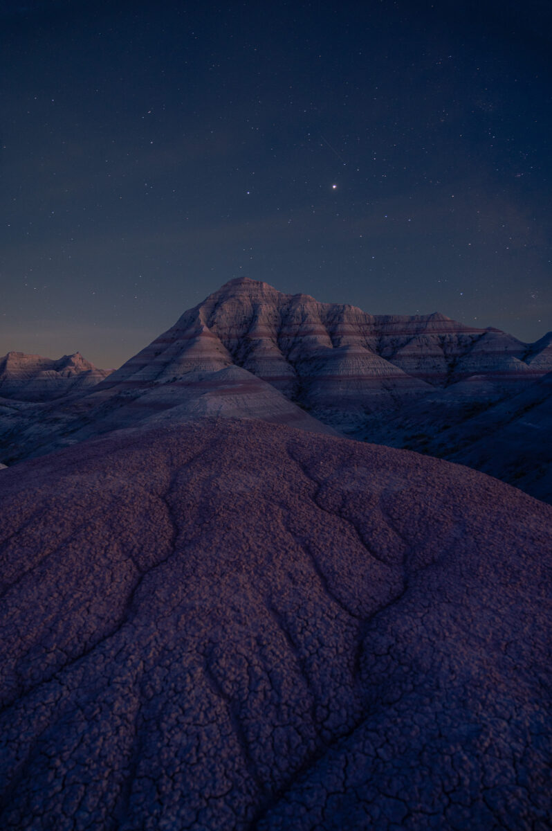 night color landscape photo of sky and dunes in Badlands in South Dakota by Erin Cahill