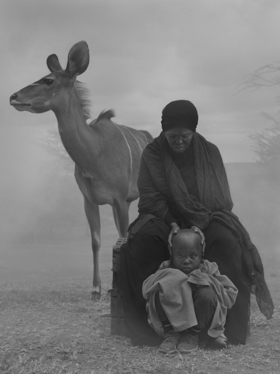 Black and white portrait of woman, baby and deer by Nick Brandt