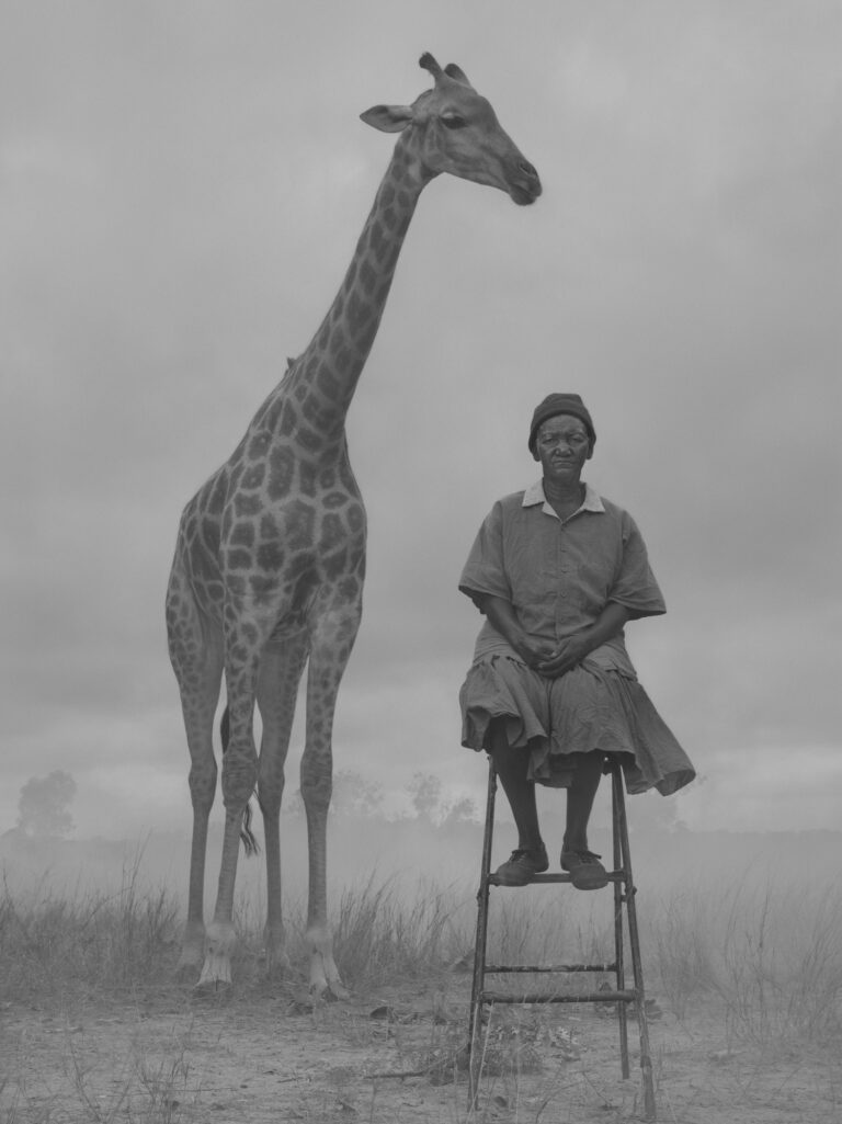 Black and white portrait of woman and giraffe by Nick Brandt