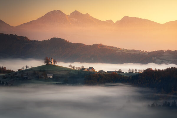 color landscape photo of mountains, village and misty sunrise in Solovenia by Matteo Rovatti