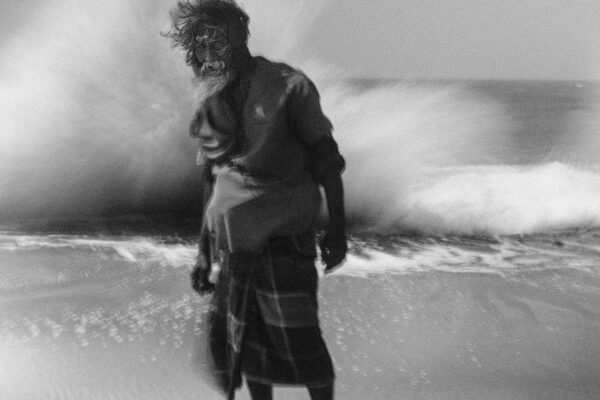 black and white portrait of a man on the beach in Northern Sri Lanka by Adam Docker