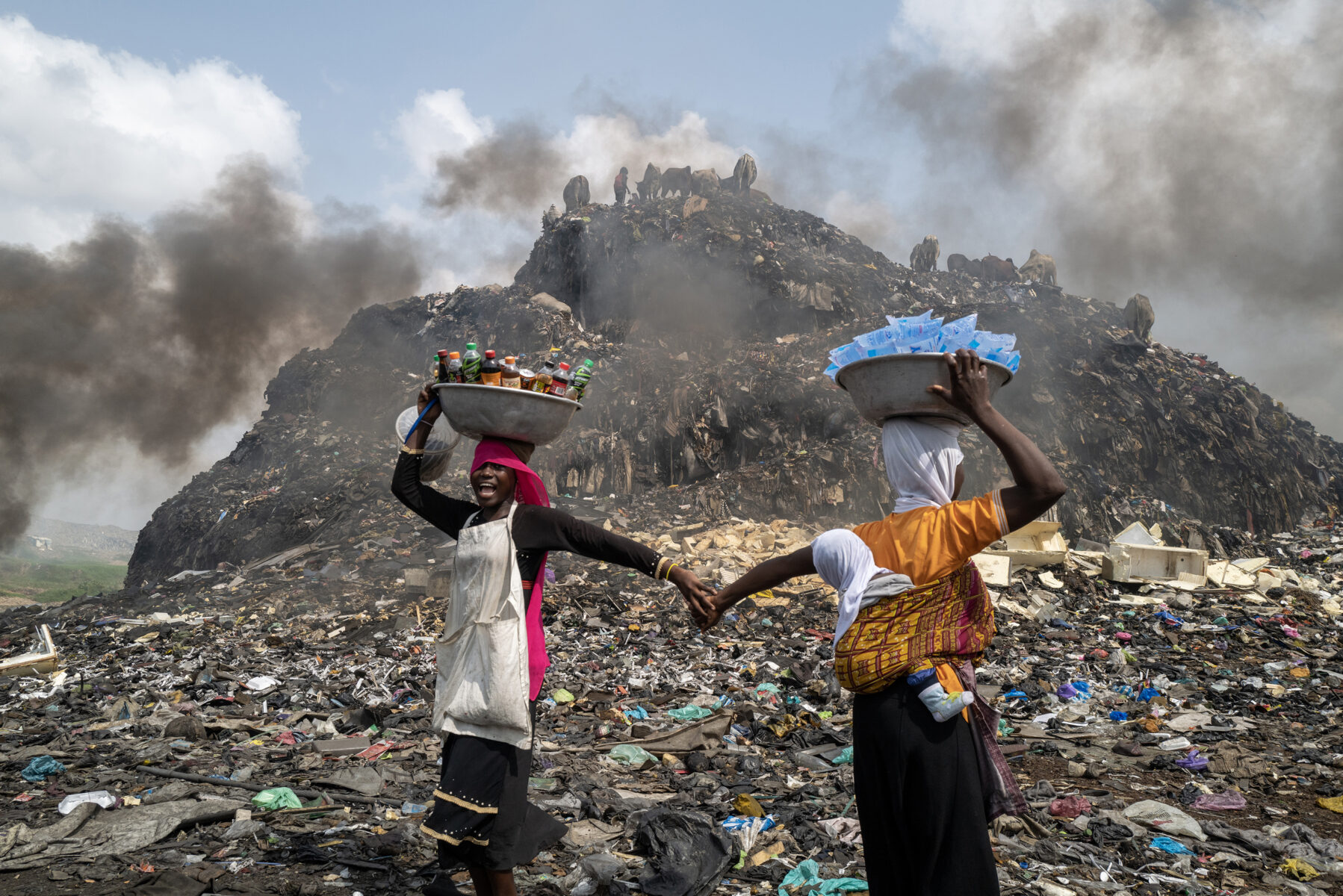 color photo of two women sellers at Agbogbloshie waste dump in Accra, Ghana by Kasia Trojak