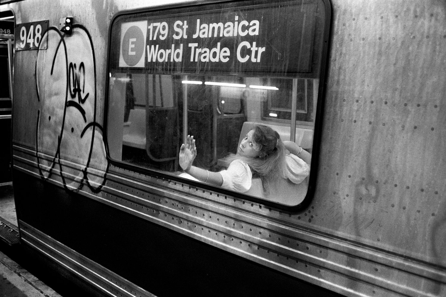 Black & white street photography by Richard Sandler, young girl on metro, NYC, 1984