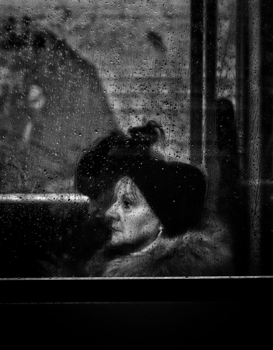 black and white street photo of woman in bus by Ahmad Badr