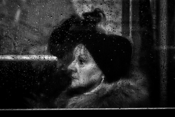 black and white street photo of woman in bus by Ahmad Badr