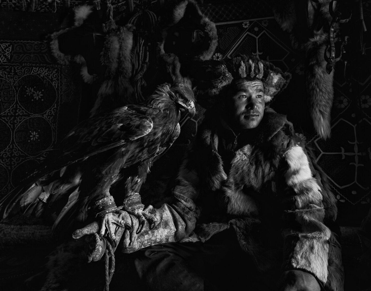 black and white portrait of a kazakh eagle hunter in western mongolia by Alessandra Manzotti