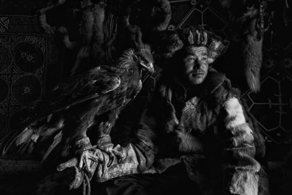 black and white portrait of a kazakh eagle hunter in western mongolia by Alessandra Manzotti