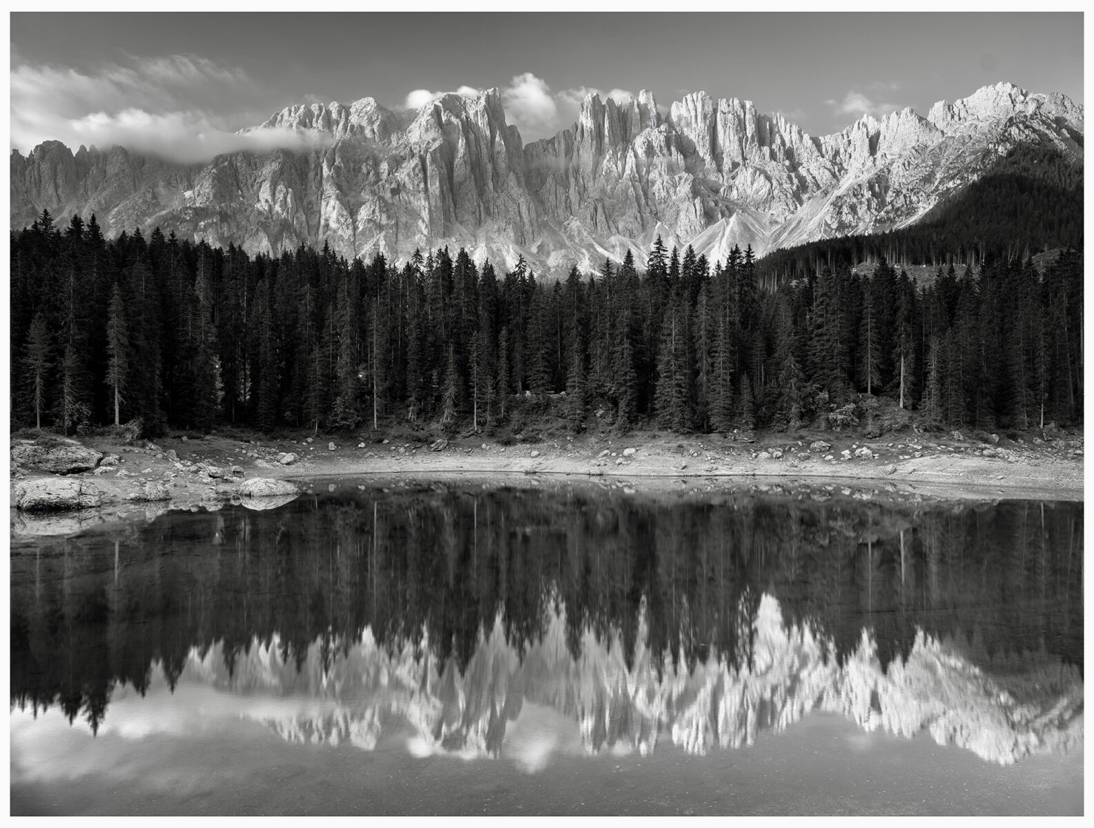 black and white landscape photo of mountains and Lake Carezza, Italy by Charlotte Ladefoged