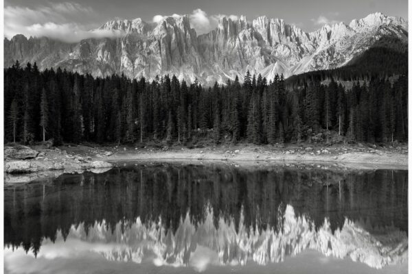 black and white landscape photo of mountains and Lake Carezza, Italy by Charlotte Ladefoged