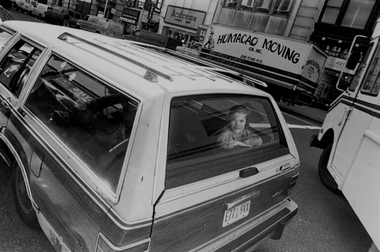 Black & white street photography by Richard Sandler, child in car