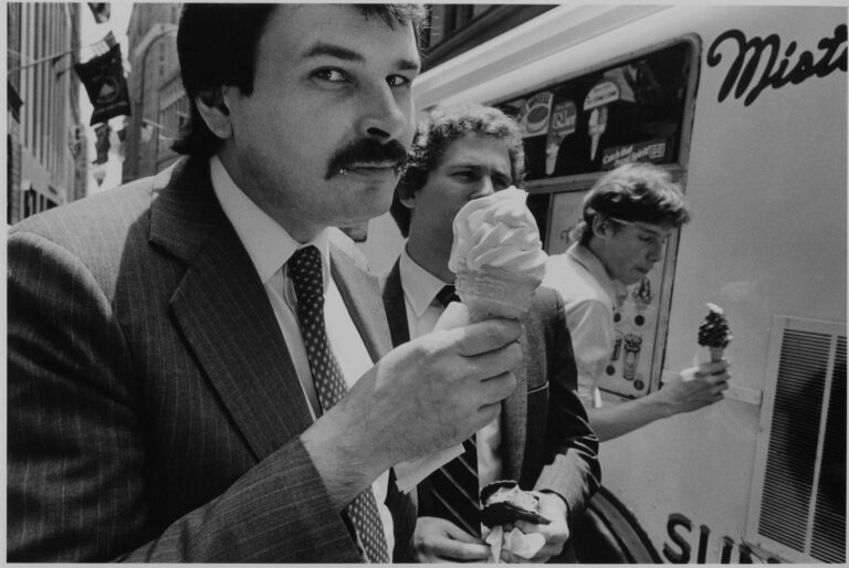 Black & white street photography by Richard Sandler, men in suits eating ice cream