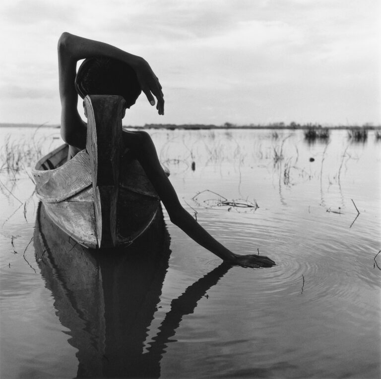 Black & white portrait photography by Monica Denevan. Boy in boat, Burma, Myanmar