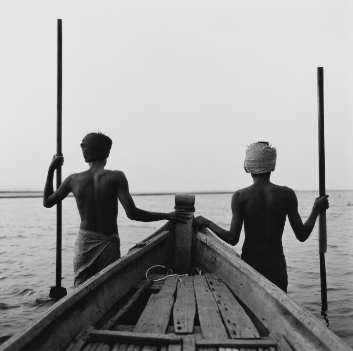 black and white medium format photo of men in water in Burma by Monica Denevan