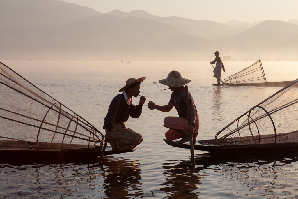 color travel photo of men on wooden boat in Myanmar by Steve Taylor